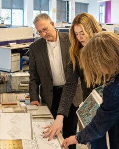 Photo of Richard Borrelli reviewing concepts with WBRC Interior Design team